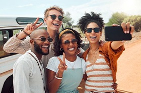 Happy group of friends taking a selfie together