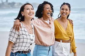 Group of friends walking on the beach