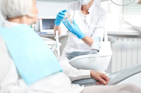 Dentist and patient discussing candidacy for All-on-4 treatment