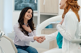 Dental patient shaking hands with dentist