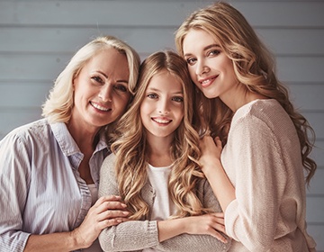 Smiling family of three