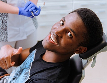 Smiling dental patient in dental chair
