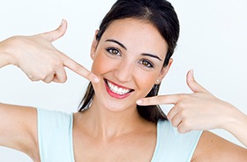 Woman pointing to flawless smile