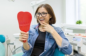 Woman looking at smile in mirror