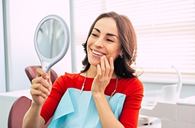 Woman looking at smile in mirror