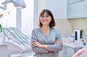 Smiling woman standing in dental treatment room
