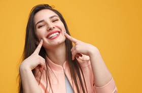 Woman showing off smile with dental bridges in Branford