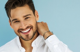 Handsome, smiling man enjoying benefits of dental bridges