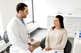 Patient talking to dentist about cost of dental bridge