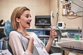 happy dental patient with mirror