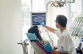 Dentist and patient reviewing X-ray together