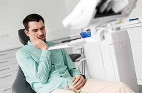 Man with toothache visiting his Branford emergency dentist