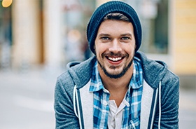 Young man outdoors smiling