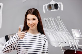 Patient in treatment room, making thumbs up gesture