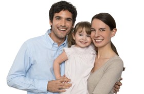 Parents and toddler daughter smiling with healthy teeth