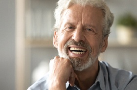Senior man enjoying the benefits of his implant dentures