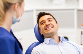 Young man smiles after getting dental implants in Branford