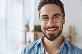 Young man with dental implant in Branford smiles