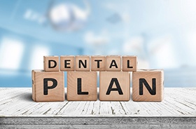 Dental Plan written on wooden blocks, sitting on tabletop