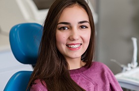 Young woman with braces in dental chair