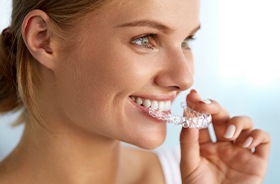 Woman placing Invisalign tray