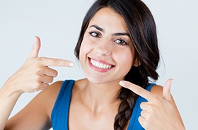 Woman pointing to flawless smile