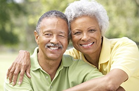 Smiling older man and woman outdoors