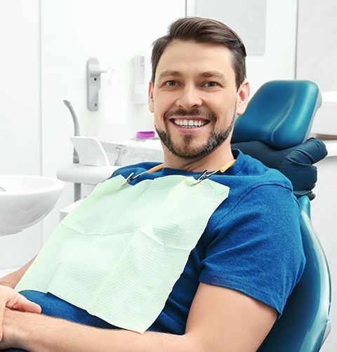 Smiling man in dental exam chair