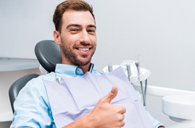 dental patient giving thumbs up