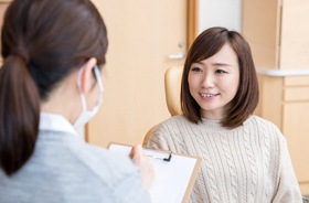 Female patient and dentist during smile makeover consultation