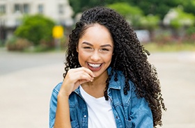 Smiling young woman, happy she could afford traditional braces in Branford