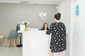 Dental team member assisting patient at front desk