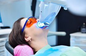 Woman undergoing in-office teeth whitening procedure