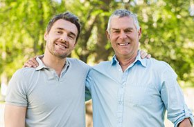 Father and adult son, both possible candidates for dental implants
