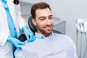 Dental patient smiling prior to tooth extraction in Branford