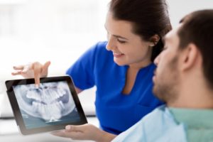 Emergency dentist in Branford using X-Ray to discuss tooth sensitivity