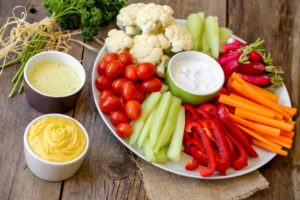 Plate of raw vegetables with dip