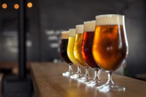 Row of beers arranged on countertop