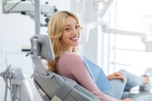 Happy dental patient looking over her shoulder