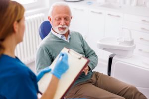 Senior man talking with his dentist