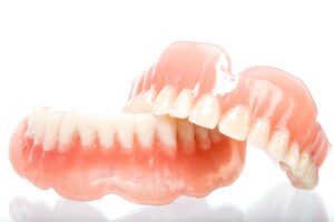 Upper and lower dentures shown against white background