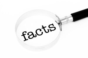 The word &ldquo;facts&rdquo; displayed under a magnifying glass 
