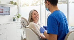 Happy senior patient talking with her dentist